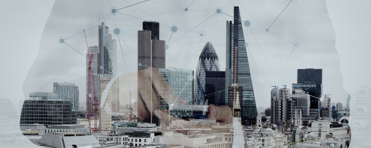 Double exposure of success businessman using smart phone and social media diagram with london city blurred background